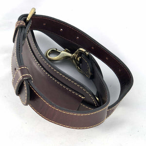 Burgundy leather shoulder strap coiled showing billet and snap clip