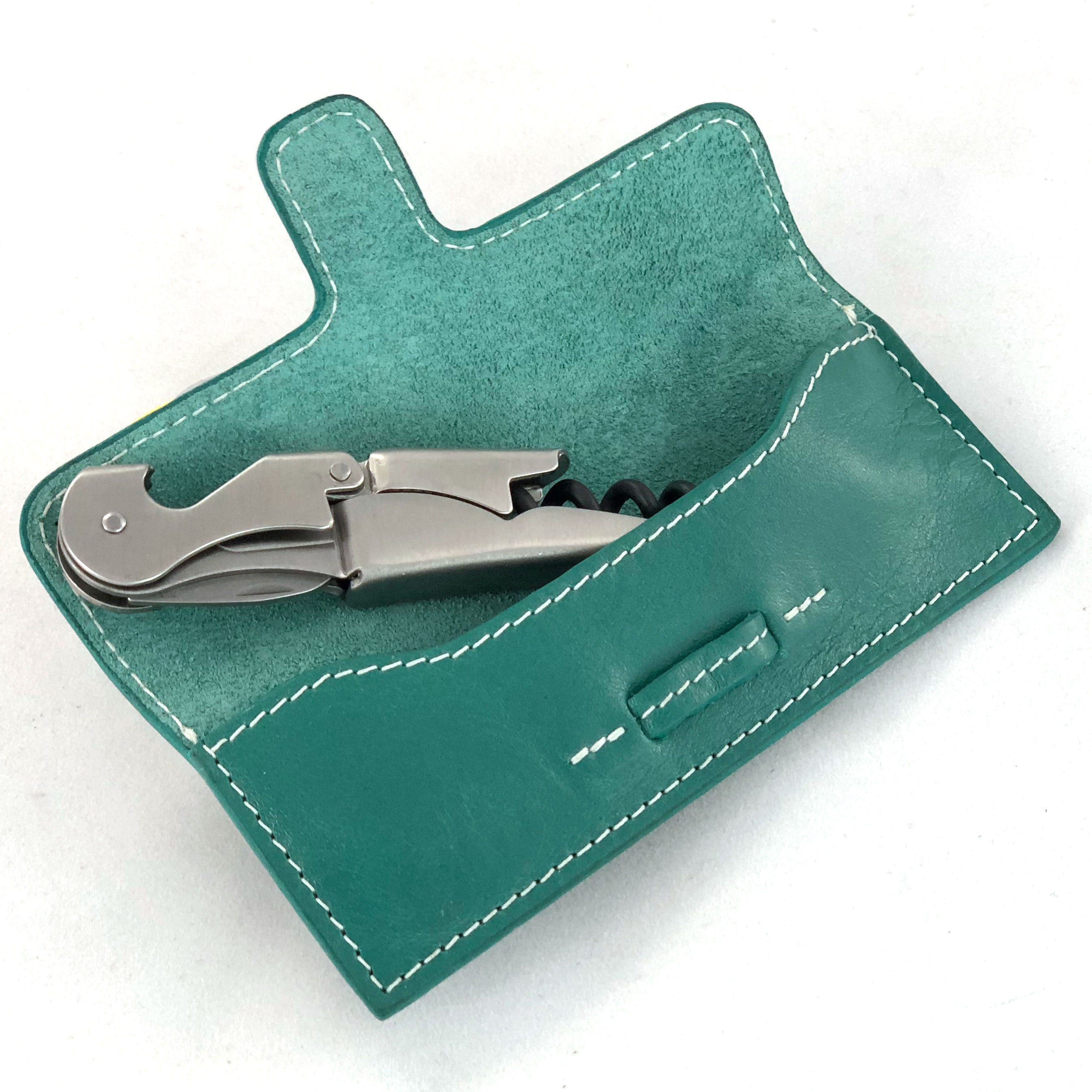 Leather case with stainless steel corkscrew, shown open from front.