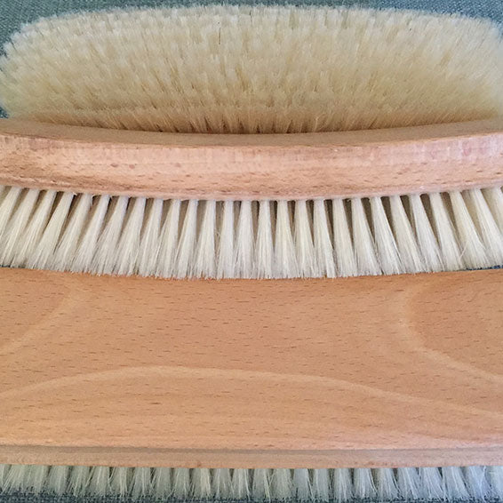 Clothing and shoe brushHorsehair and oak clothing and shoe brush showing  the bottom and side, best for lint, pet hair and buffing shoes close up of 3 pieces, showing top, side and bottom. Best for lint, pet hair and buffing shoes